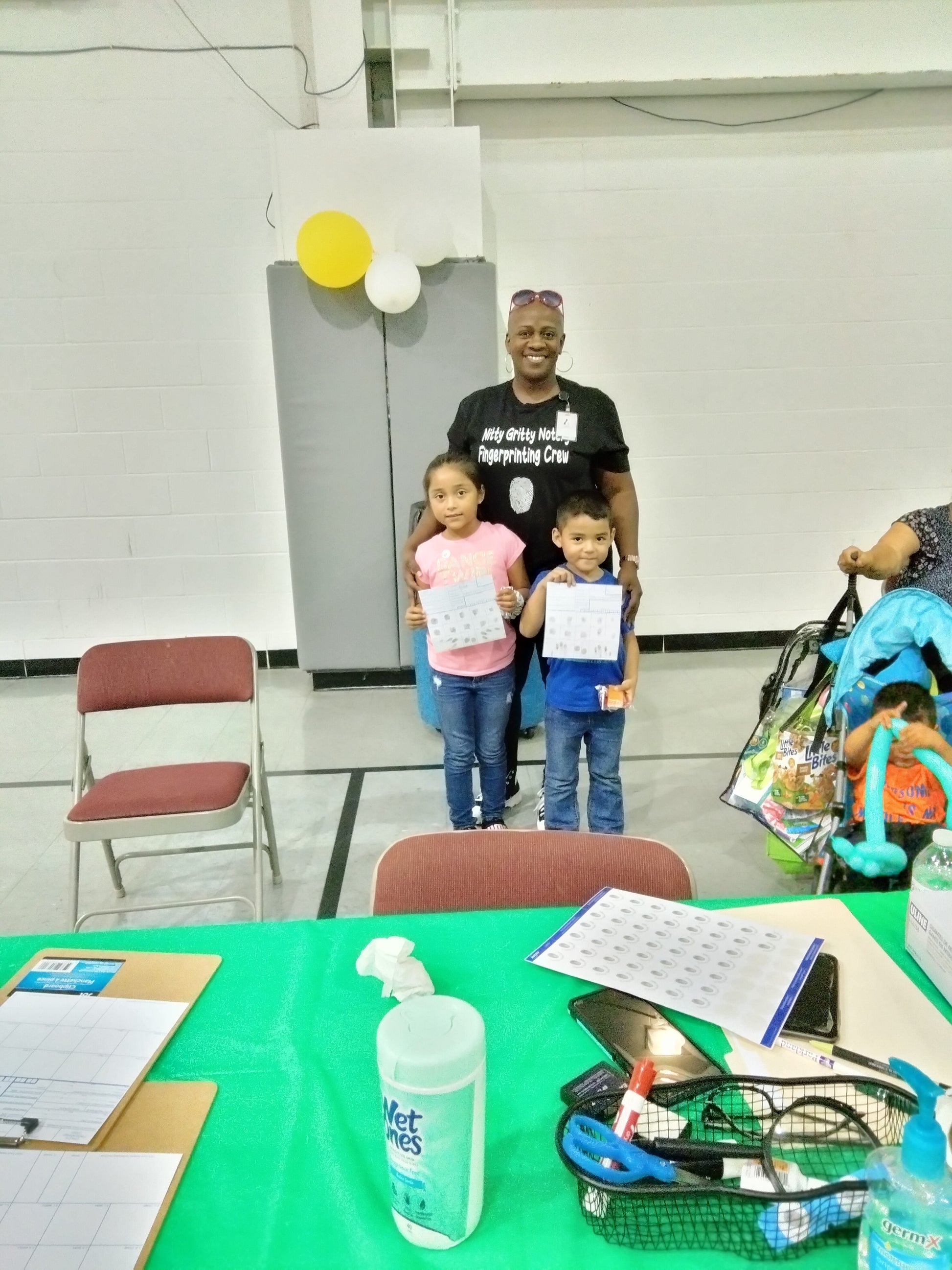 Children with their safety cards standing with owner of Elite Biometrics